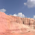 Colorful Danxia Landform With Red Orange Rock Formations Under Blue Sky And White Clouds