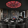 Private Dining Room Interior With Round Table Black Leather Chairs And Red Floral Ceiling Light