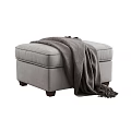 Comfortable Gray Upholstered Ottoman With Cozy Knit Blanket And Wooden Legs