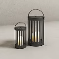 Black Metal Candle Lanterns with Vertical Slats and White Candles in Minimalist Setting