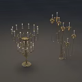 Golden Metal Candle Holders With Multiple Arms And Floral Decorations In Dark Background