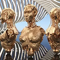 Three Golden Robotic Humanoid Busts With Intricate Mechanical Design In Spiral Background