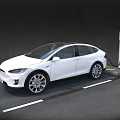 White Tesla SUV Electric Car Charging At Tesla Charging Station In Parking Lot