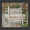 Rustic Wooden Pallet Structure With Green Foliage And Garden Tool On Soil Mat