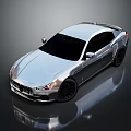 Silver Maserati Sedan With Sleek Design And Black Wheels On Reflective Surface