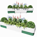 White Flower Planters With Green Accents Holding Various Red Blue Blooms Bushes And Ferns