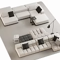 Beige Sectional Sofa With Black Cushions Side Table And Floor Lamp On Rug