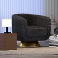 Modern Table Lamp on Wooden Side Table with Fuzzy Black Armchair and Stack of Books