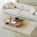 Modern Light Colored Sofa With Cushions And Wooden Coffee Table On Beige Rug