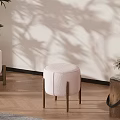 Pink Round Leisure Chair with Wooden Legs on Wooden Floor White Wall and Plant Shadows