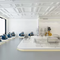Modern Exhibition Hall Showcasing Yellow And Blue Industrial Pumps On White Platforms