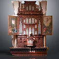 Antique Oil Paintings Flanking Ornate Wooden Carved Pipe Organ with Intricate Design Details