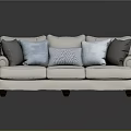 Cream Fabric Sofa With Rolled Arms Dark Wooden Legs And Gray Light Blue Throw Pillows
