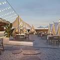 Outdoor Restaurant With White Tents String Lights Tables Chairs Green Plants Pebble Ground Evening