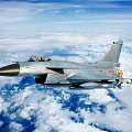 Modern Fighter Jet Flying Over Clouds With Missiles And Military Insignia