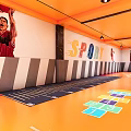 Basketball Court Interior With Orange Ceiling Red Orange Floor Basketball Hoops And Athlete Poster On Wall