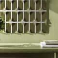 White Grid Abstract Painting On Green Wall With Vase Green Plant And Books On Table