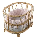 Stylish Wicker Baby Crib With Pink Braided Accents And Gray Comfort Mattress