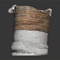 Woven Storage Basket With Brown And White Design Holding Decorative Fabric Items