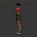 Shirtless Man in Boxing Stance Wearing Red Gloves and Black Shorts