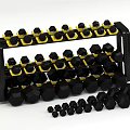 Black Dumbbells With Yellow Bases On Multi Layer Rack And Scattered Small Weights