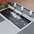 Outdoor Decorative Water Fountain With Multiple Jets Koi Fish And Lush Greenery By Wooden Deck