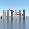 Art Installation with Gray Black Columns Red Gray Ribbons Under Blue Sky Over Water Surface