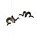 Two Sheep Skulls With Curved Horns Displayed On White Background