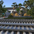 Rail Tracks As Road Infrastructure With Gravel Palm Trees Building And Greenery
