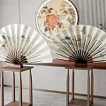Traditional Folding Fans On Wooden Stands With Round Decorative Painting In Indoor Space