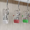 Metal Hooks Hanging On White Rod With Colored Balls Against Wooden Background
