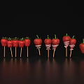 Fresh Strawberries on Wooden Sticks with White Stripes Against Black Background