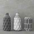 Geometric Textured Ceramic Vases in Black and White on Gray Wall