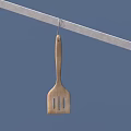 Wooden Kitchen Spatula Hanging On Metal Rod Against Blue Background