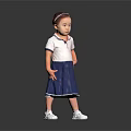 Little Girl In White Top And Blue Skirt Standing On Reflective Floor With Gray Background