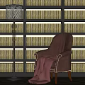 Comfy Brown Leisure Chair With Red Blanket And Floor Lamp By Bookshelf Wall With Colorful Books