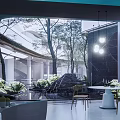 Serene Garden Landscape With Circular Platform Fire Pit Lounge Chair Water Feature And Greenery