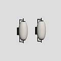Two Modern Black Metal Wall Sconces With Beige Fabric Shades Mounted On Wall