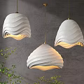 Textured White Wave Shaped Pendant Lights with Gold Hanging Chains on Grey Wall