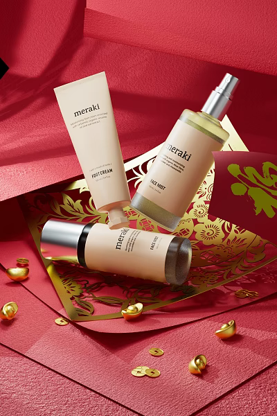 Meraki Perfume Cosmetics Skincare Products With Golden Decoration On Red Festive Background 3d model