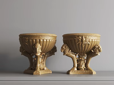 Gold Decorative Urns With Carved Lion Heads And Ornate Patterns On Tabletop 3d model