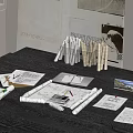 Designer Workspace On Dark Wood Table With Sketches Rolled Papers Pencils Notes And