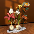 Colorful Floral Display With Orange White Pink Flowers In Spherical Vases On White Pebble Base