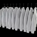 White Shirts Hanging on Hangers in a Row Against Black Background