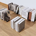Different Colored Books Stacked On Wooden Floor With Various Sizes In Display Arrangement