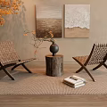 Woven Leisure Chairs With Tree Stump Table And Rug Near Paintings And Plant