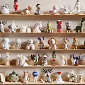 Ornamental Figurine Collection Featuring Diverse Animal and Character Designs Neatly Displayed on Multi Layered Shelves