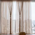 Sheer Beige Curtains with Brown Branch-like Ties Enhancing Modern City View Windows