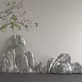 Decorative Rockery Stones with Green Twig on Gray Wall Background