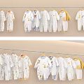 Cute Baby Onesies Hanging Display With White Yellow Blue Colors And Adorable Patterns